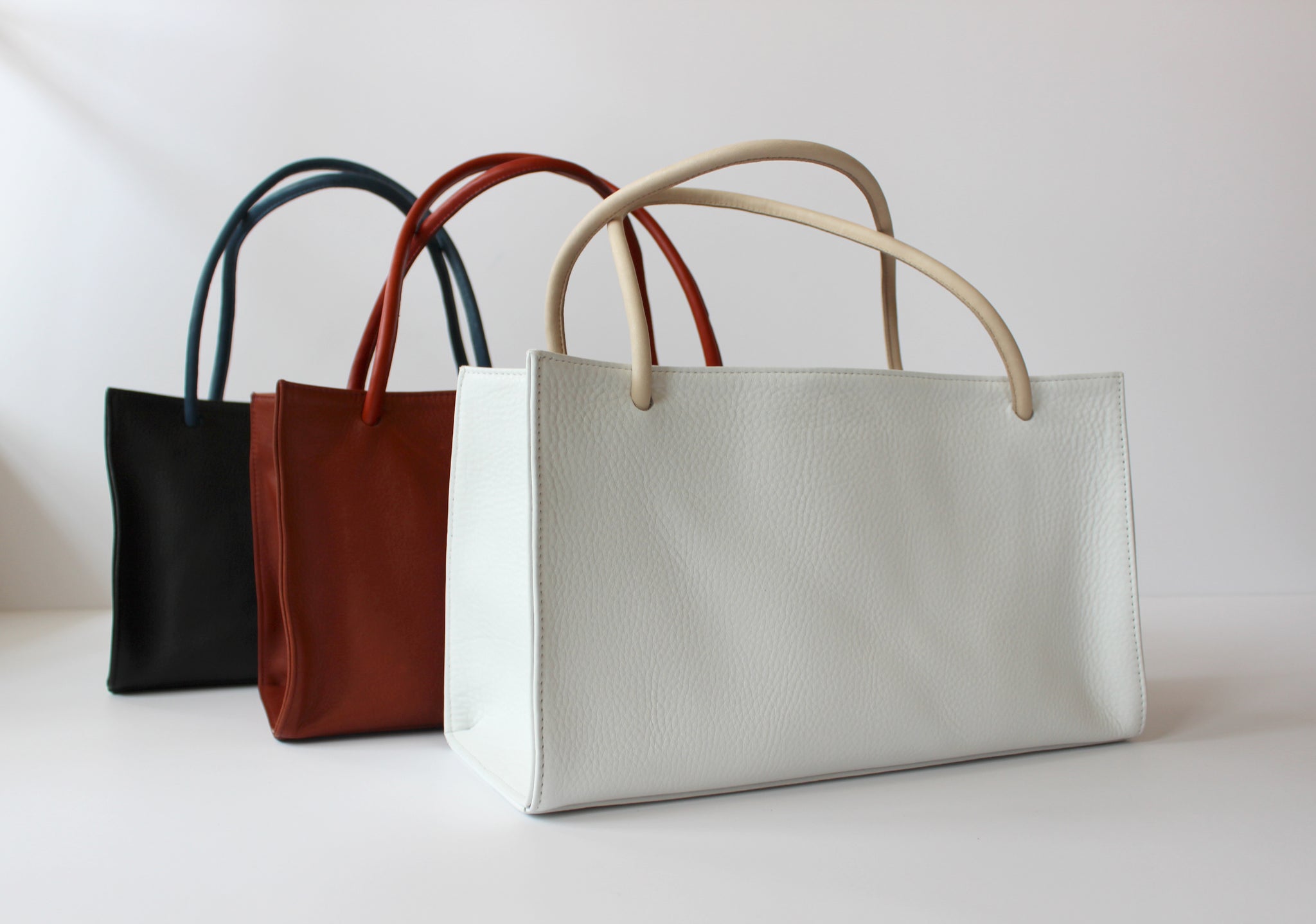 Myers Collective Porter Tote pebbled glovetan leather with contrasting leather straps and interior pockets sized for your sunnies, phone and pens.